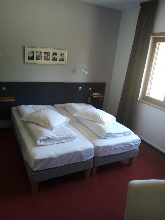 Postel nebo postele na pokoji v ubytování Hôtel Le Verger De Bischwiller