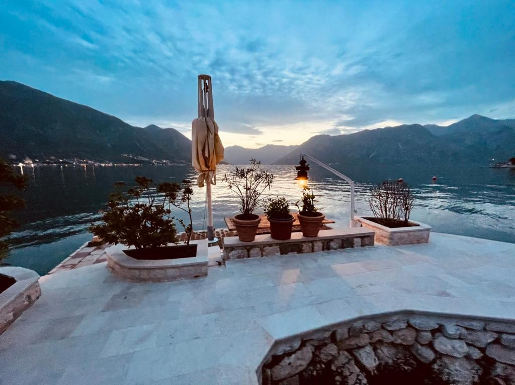 a patio with a view of the water and mountains at Casa Pantagana in Kotor