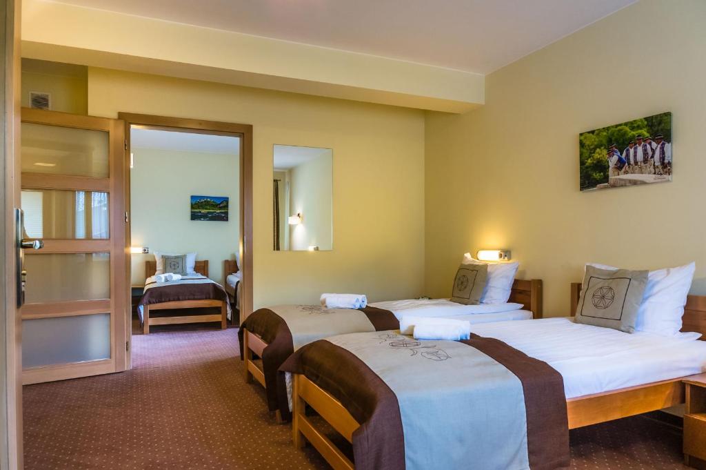 Postel nebo postele na pokoji v ubytování Hotel Pod Wulkanem