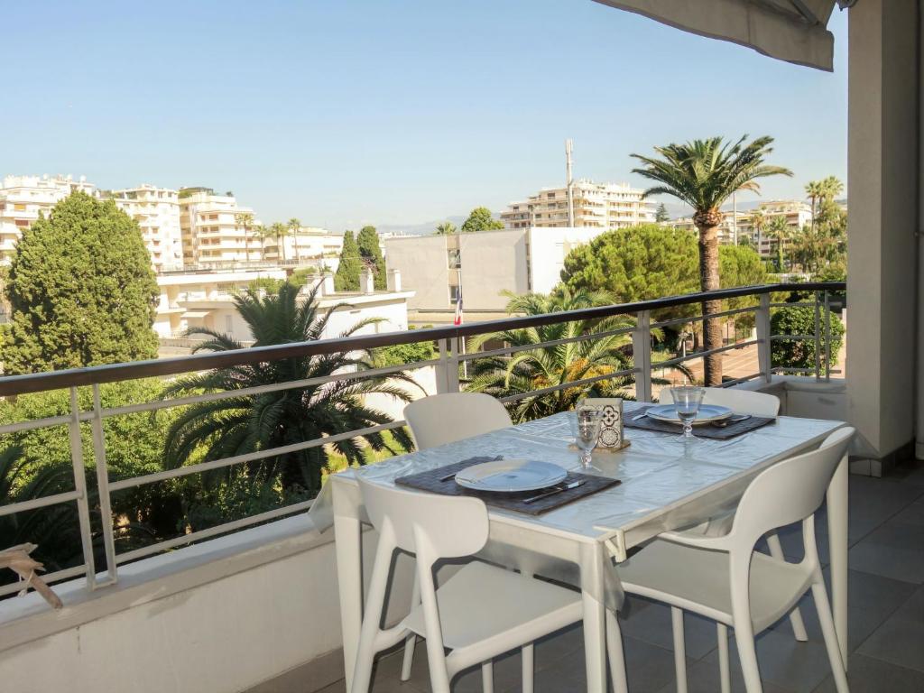 a table on a balcony with a view of the city at Apartment Cristal Croisette-1 by Interhome in Cannes