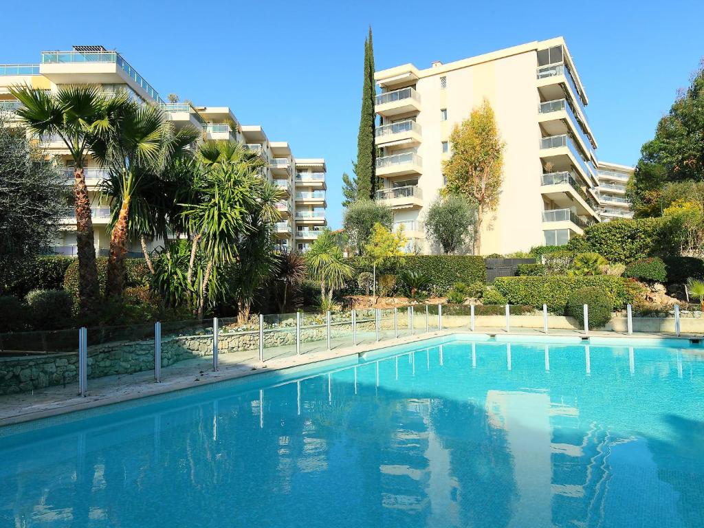 a large swimming pool in front of a building at Studio Le Floriana by Interhome in Cannes