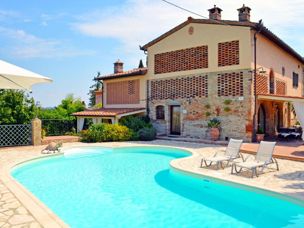 a house with a swimming pool in front of a house at Holiday Home La Vecchia Pieve by Interhome in Castelfiorentino