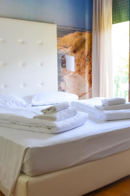 Postel nebo postele na pokoji v ubytování Hotel Regina