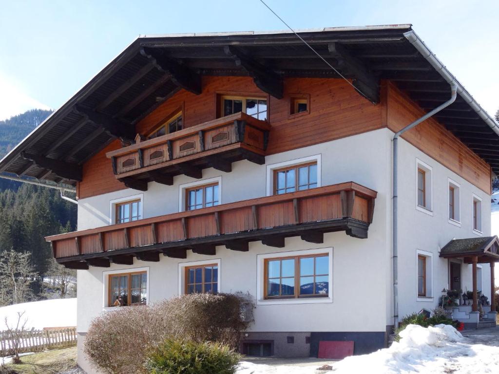 a large house with a wooden roof at Apartment Eisenhut - EBE500 by Interhome in Hüttau