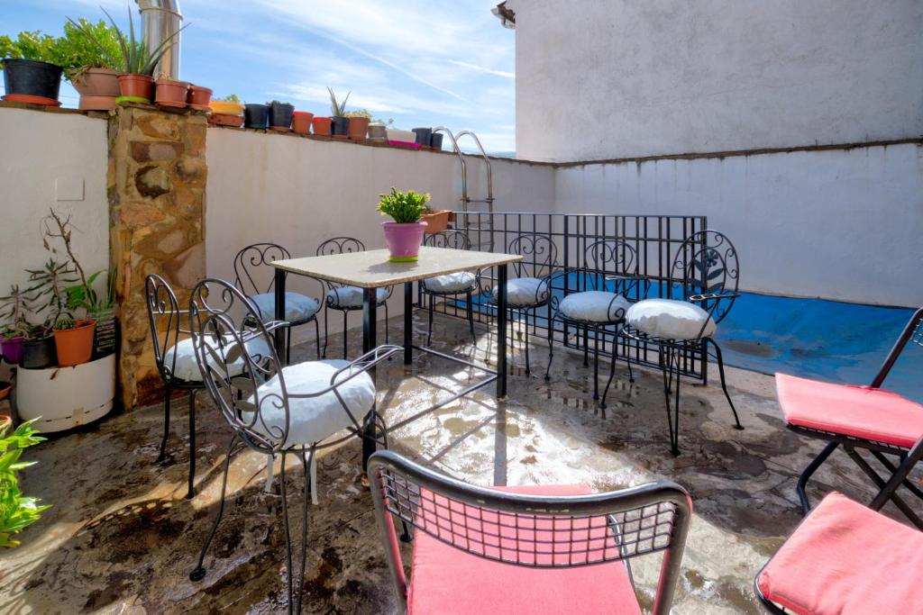 a patio with a table and chairs on a balcony at 6 bedrooms villa with private pool furnished terrace and wifi at Puebla de Don Rodrigo in Puebla de Don Rodrigo