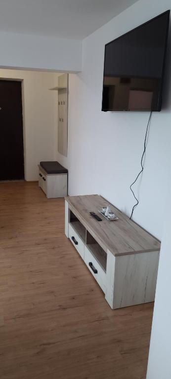 a living room with a tv on a wall at Apartament Crina in Jurilovca
