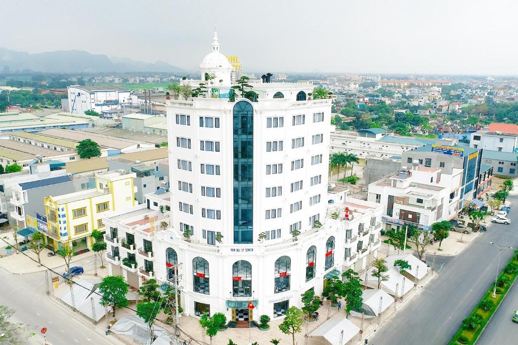 an aerial view of a white building in a city at Khách sạn VHL Hà Nam in Phủ Lý