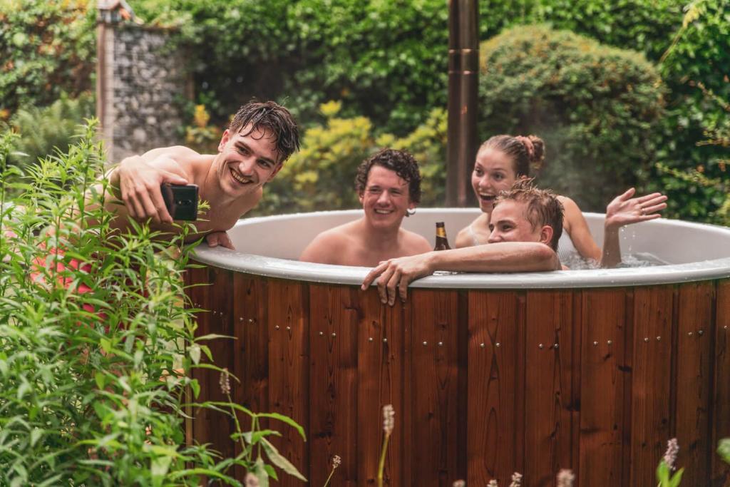 a group of people in a bath tub at The Black Swan Hotel in Bruges