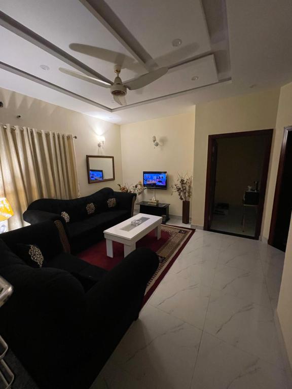 a living room with a couch and a table at Lovely 1-Bed House in Lahore in Lahore