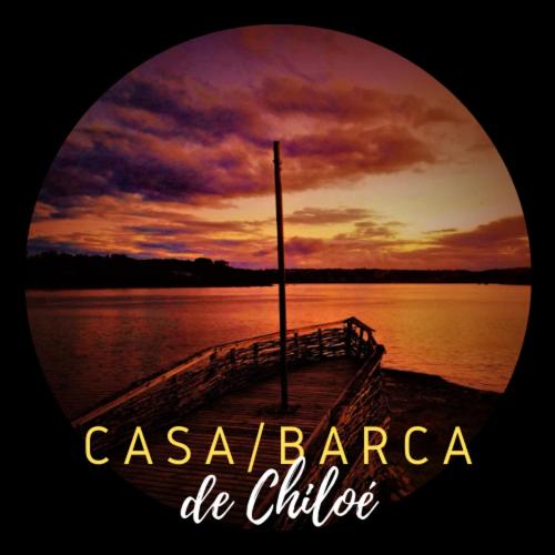 a photograph of a dock on a lake at sunset at CASA BARCA DE CHILOÉ in Castro