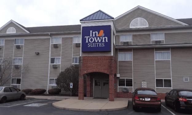 a inn tum tum suites sign in front of a building at InTown Suites Extended Stay Minneapolis MN - Coon Rapids in Coon Rapids
