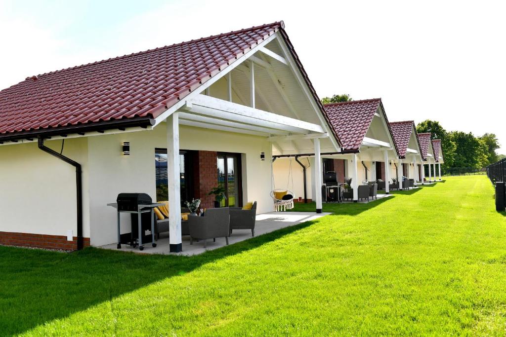 a row of cottages on a green lawn at Apartamenty na Dworskiej in Spytkowice