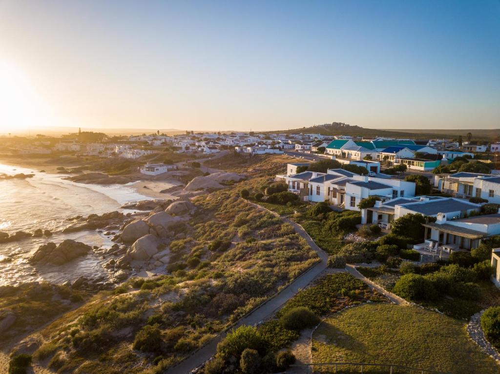 an aerial view of a village next to the beach at La Baleine in Paternoster