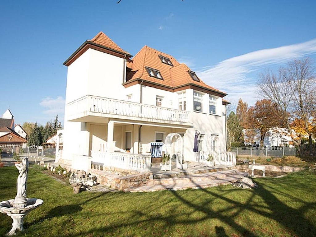 a large white house with a roof at Villa Seenland in Böhlen