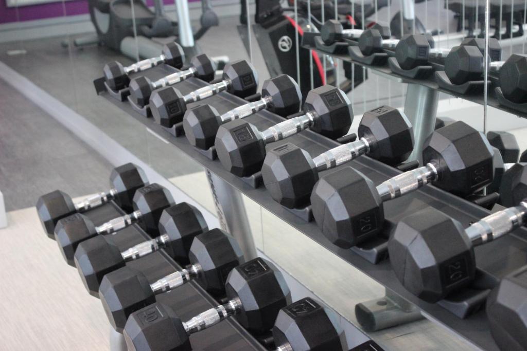 a row of dumbbells on display in a gym at Crowne Plaza Leon, an IHG Hotel in León