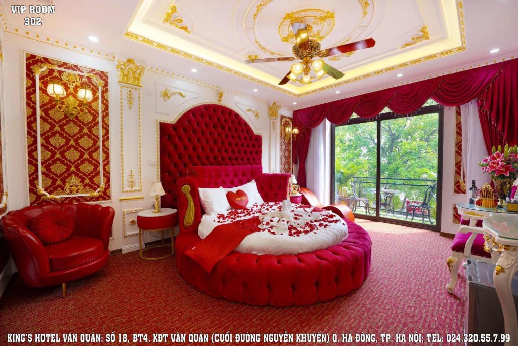 a bedroom with a red bed and a red chair at King's Hotel Văn Quán in Hanoi