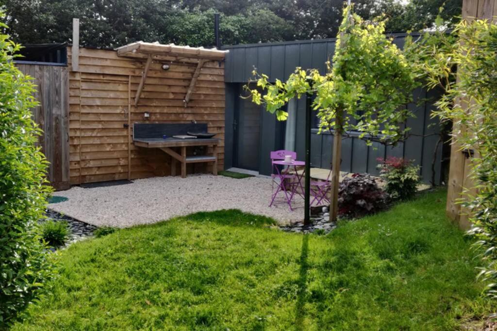 a backyard with a ping pong table and a fence at Gite La Basse-Cour in Cordemais