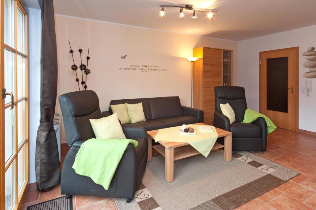 a living room with two chairs and a table at Ferienpark Freesenbruch Wohnung 4 2 - Ostseeperle in Zingst