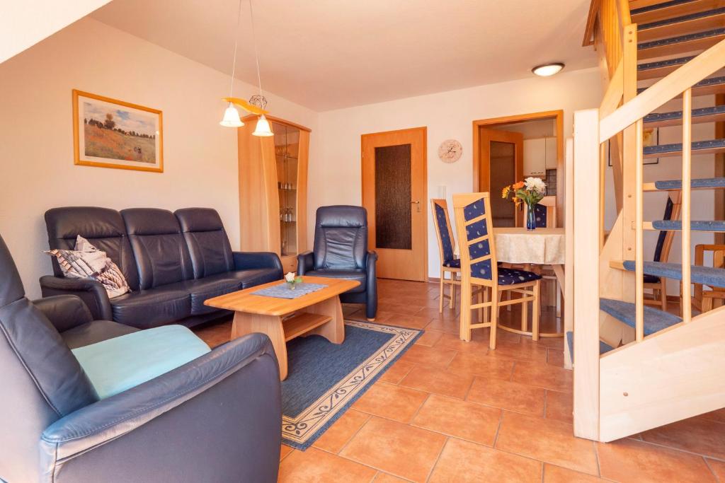a living room with a couch and a table at Ferienpark Freesenbruch Wohnung 3 5 - Muschelsucher in Zingst