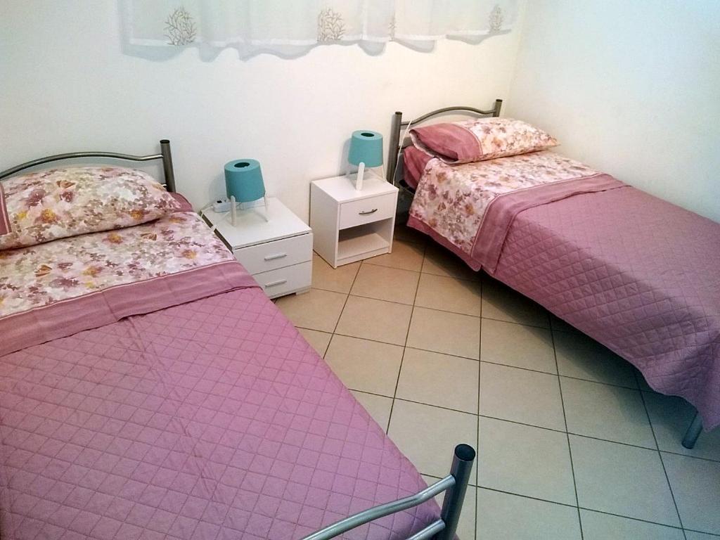 Łóżko lub łóżka w pokoju w obiekcie Appartamento La Bonifica