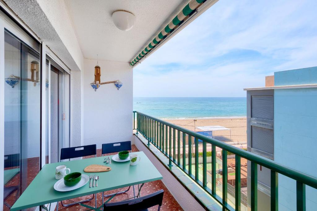 a balcony with a table and a view of the beach at LG Sea Views in Calafell