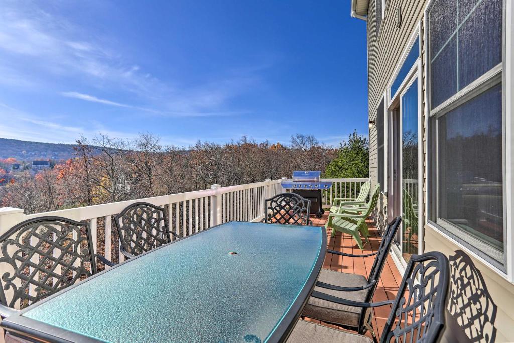 a table and chairs on the balcony of a house at New ! Slopeside Townhome : WFH, Ski, Dine & Hike in Tannersville