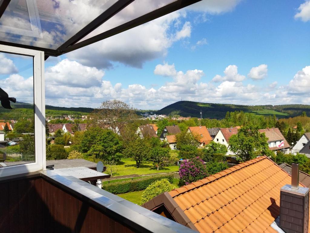 a view of a town from the balcony of a house at Ferienwohnung Harz Valley -Mit Fernblick in den Harz. in Goslar