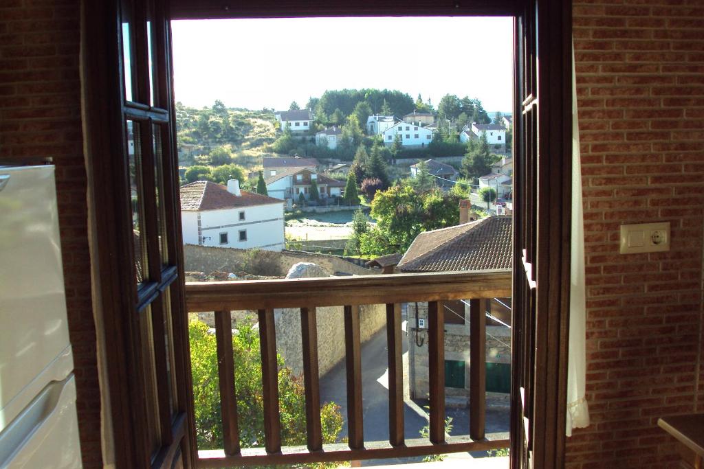 an open window with a view of a city at Artesano II in Navarredonda de Gredos