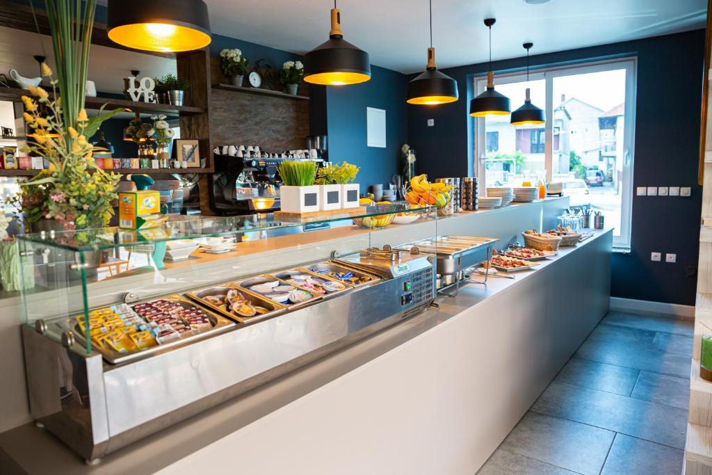a bakery counter with many different types of pastries at Hotel Sky in Zadar