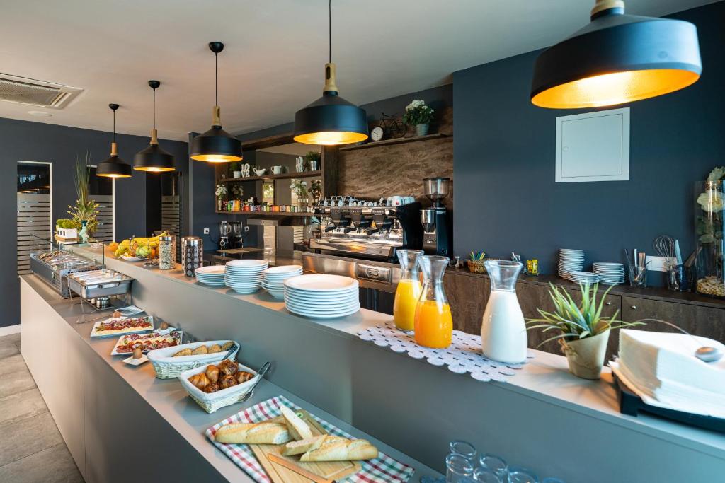 a buffet line with plates of food and drinks at Hotel Sky in Zadar