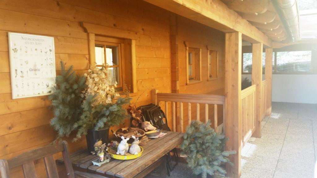 a wooden cabin with stuffed animals sitting on a bench at Appartements Kirchgasser Radstadt in Radstadt