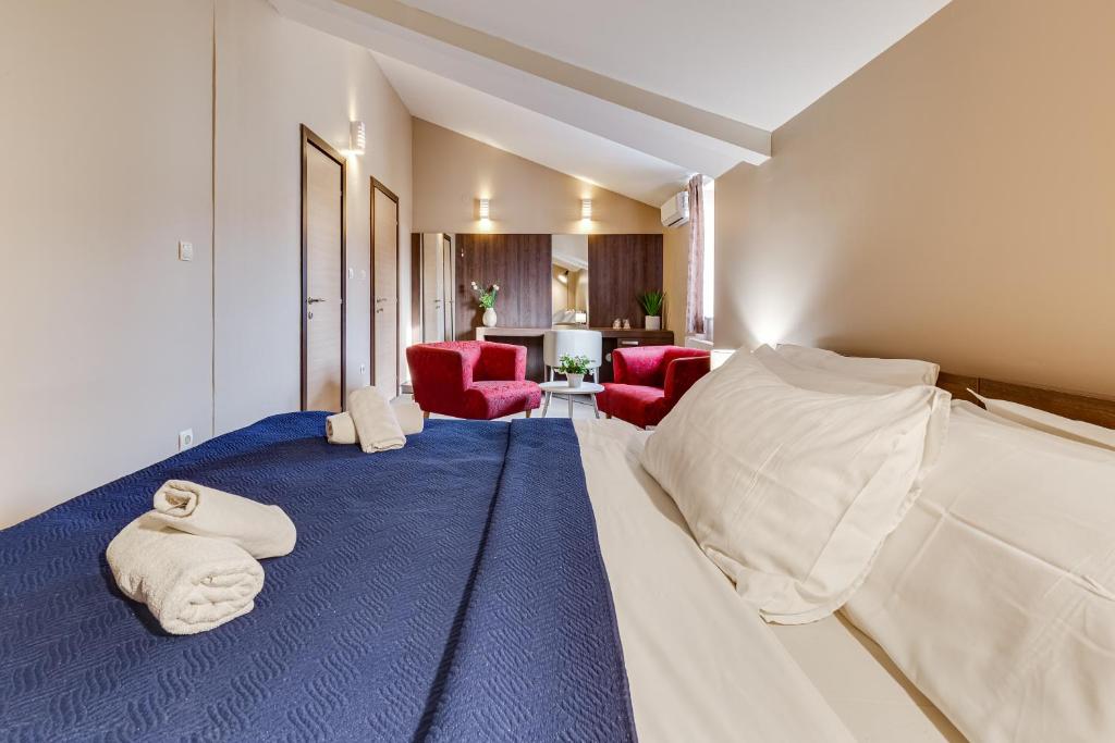 a hotel room with a bed with towels on it at Hotel Sky in Zadar