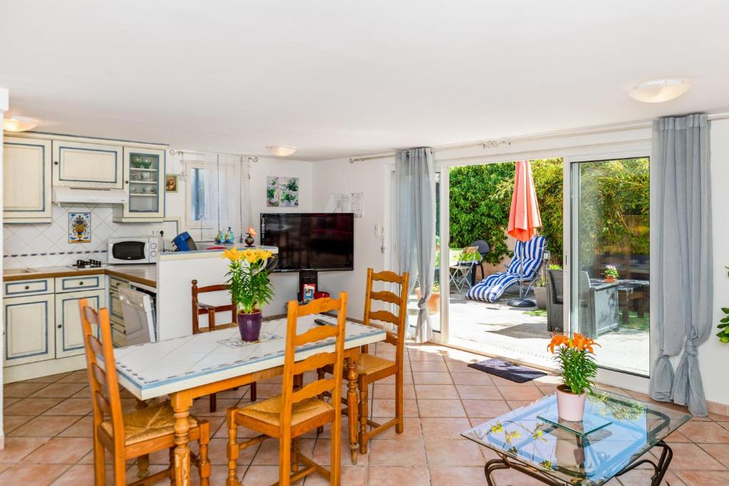 a kitchen and dining room with a table and chairs at Maison d'une chambre avec jardin clos et wifi a Arles sur Tech in Arles-sur-Tech