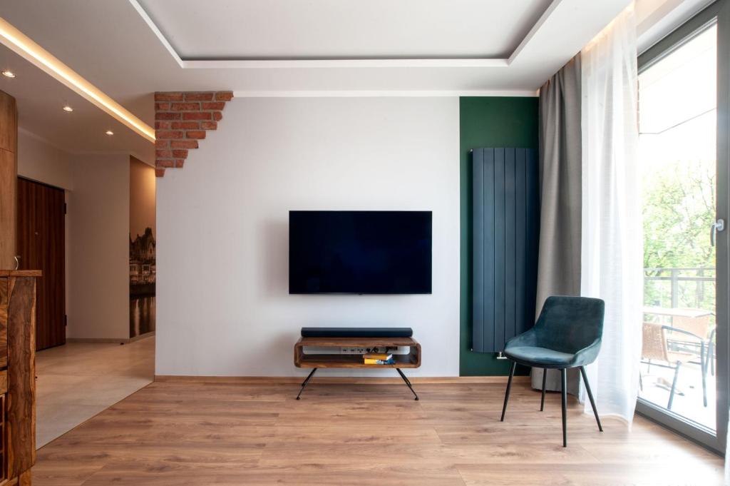 Televízia a/alebo spoločenská miestnosť v ubytovaní M&J Apartments - Garden Gates