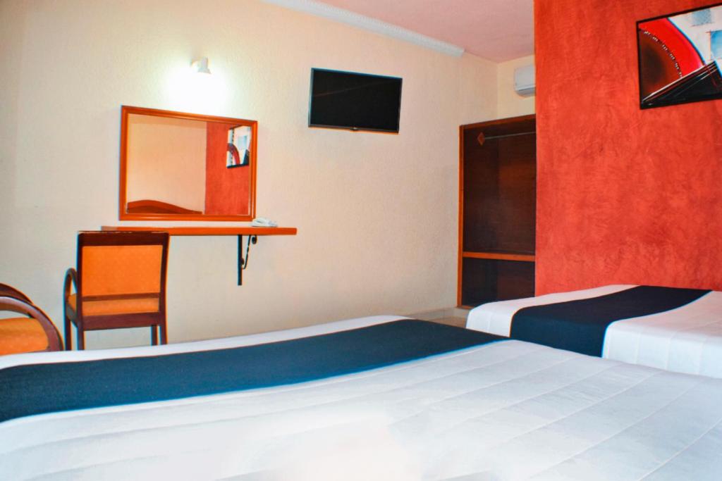 Postel nebo postele na pokoji v ubytování Hotel Hacienda Sánchez