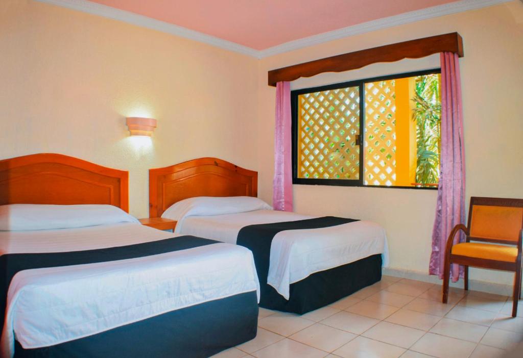 Postel nebo postele na pokoji v ubytování Hotel Hacienda Sánchez
