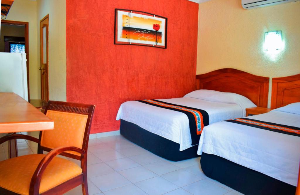 Postel nebo postele na pokoji v ubytování Hotel Hacienda Sánchez