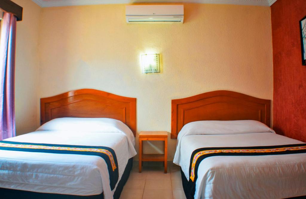 Postel nebo postele na pokoji v ubytování Hotel Hacienda Sánchez