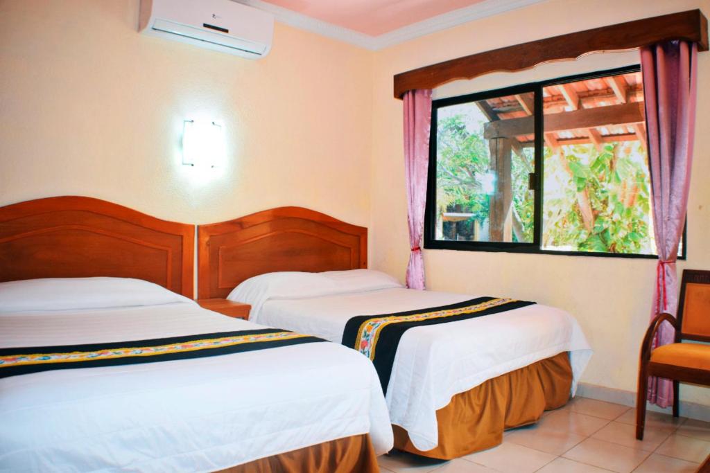 Postel nebo postele na pokoji v ubytování Hotel Hacienda Sánchez