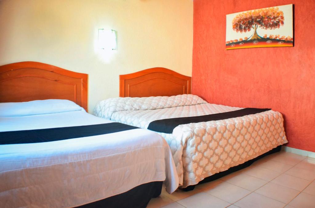 Postel nebo postele na pokoji v ubytování Hotel Hacienda Sánchez