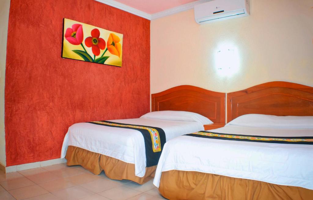 Postel nebo postele na pokoji v ubytování Hotel Hacienda Sánchez