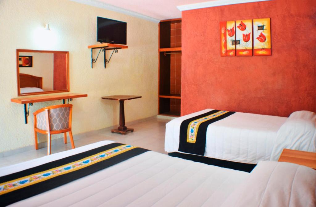 Postel nebo postele na pokoji v ubytování Hotel Hacienda Sánchez