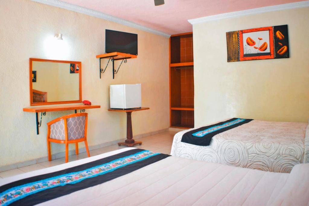 Postel nebo postele na pokoji v ubytování Hotel Hacienda Sánchez