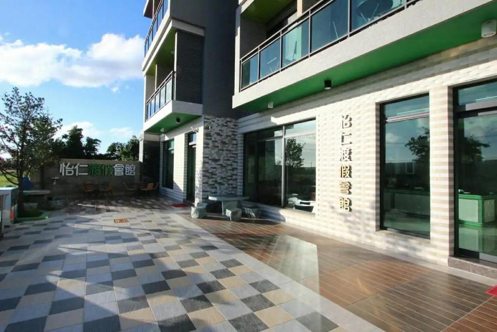 a large building with a checkered floor in front of it at Yiren Hotel in Hengchun