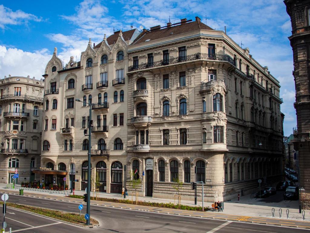 a large building on the corner of a street at City Hotel Matyas in Budapest