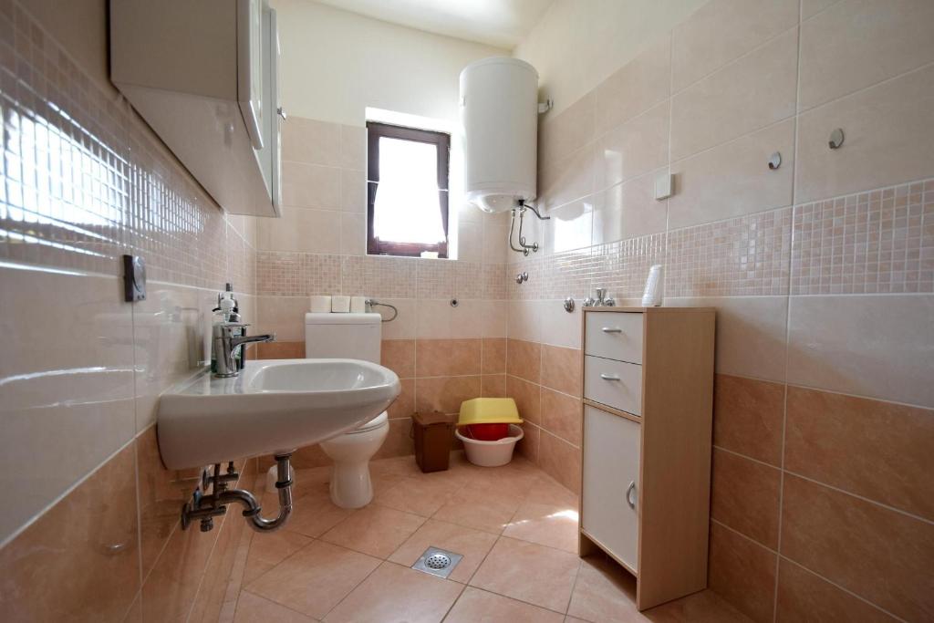 a bathroom with a sink and a toilet at Apartment Lorela in Malinska