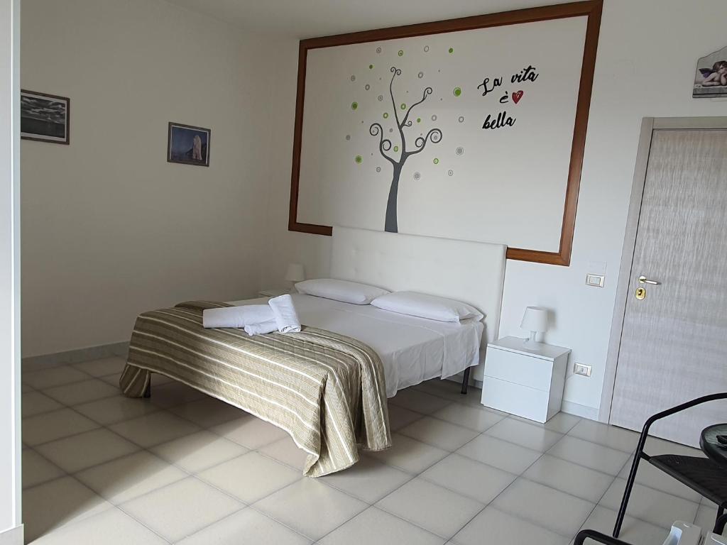 Postel nebo postele na pokoji v ubytování B&B Pizzomunno e Cristalda Rooms