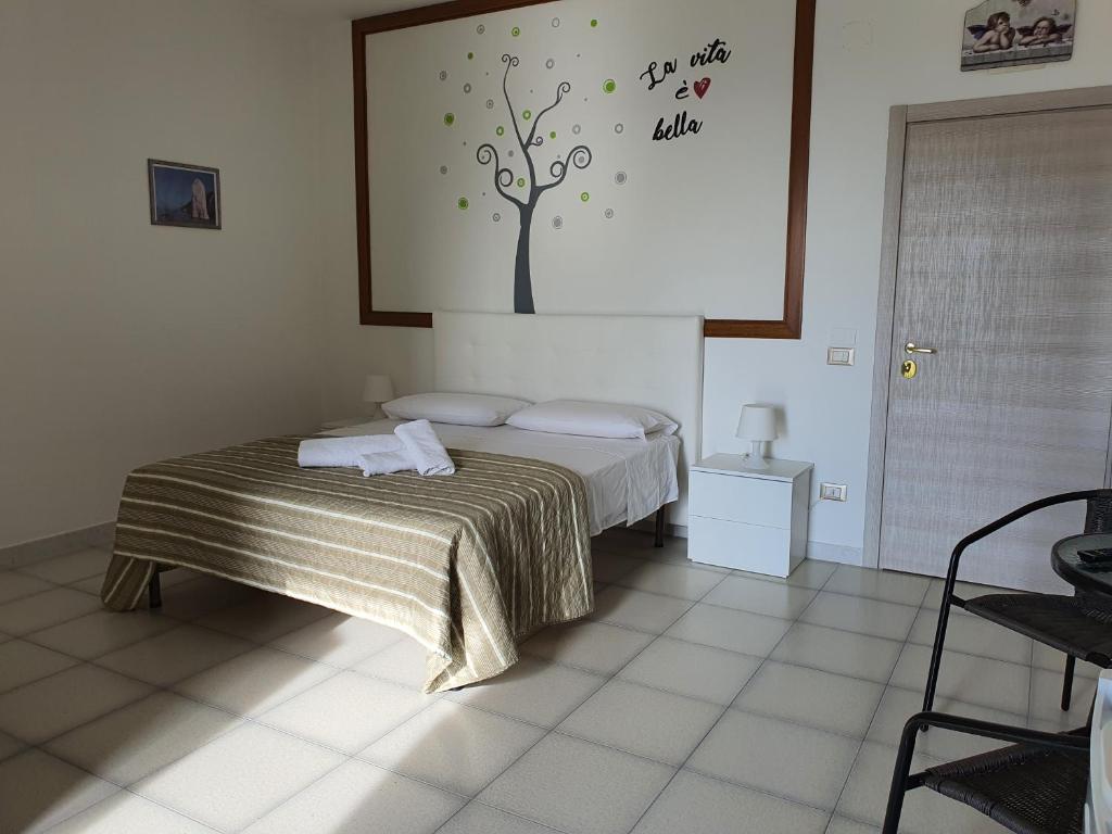 Postel nebo postele na pokoji v ubytování B&B Pizzomunno e Cristalda Rooms