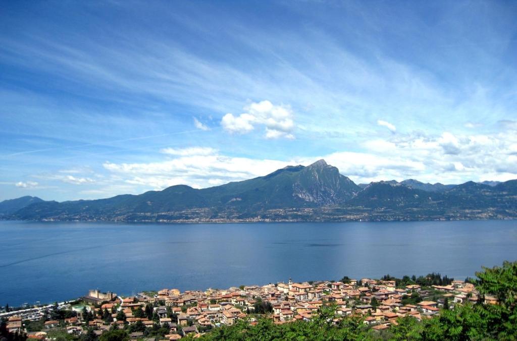 a large body of water with a city and a mountain at Antica Corte Albisano in Torri del Benaco
