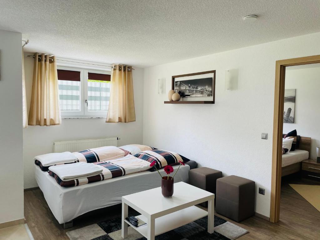 a living room with a bed and a couch at " Sunshine am See " in Friedrichshafen